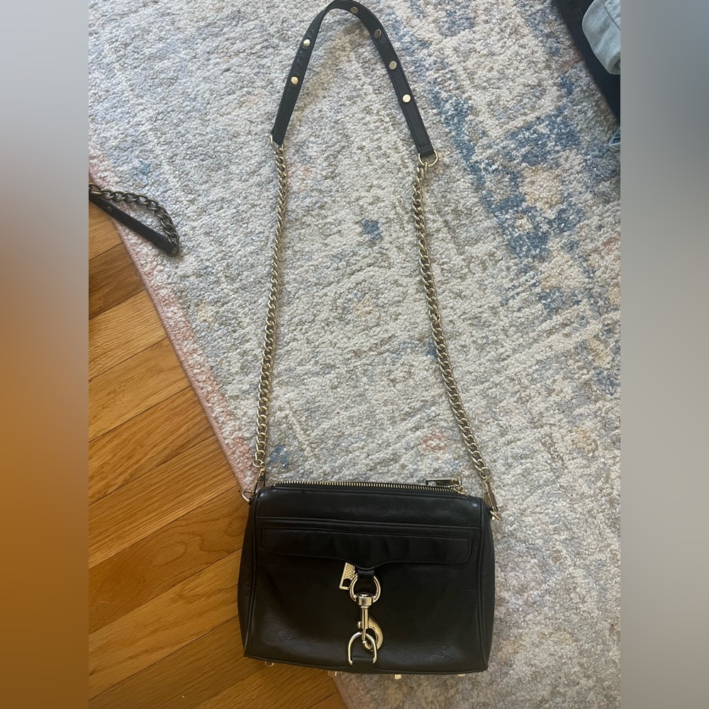 Sleek Black and Gold Crossbody Bag with Structured Design